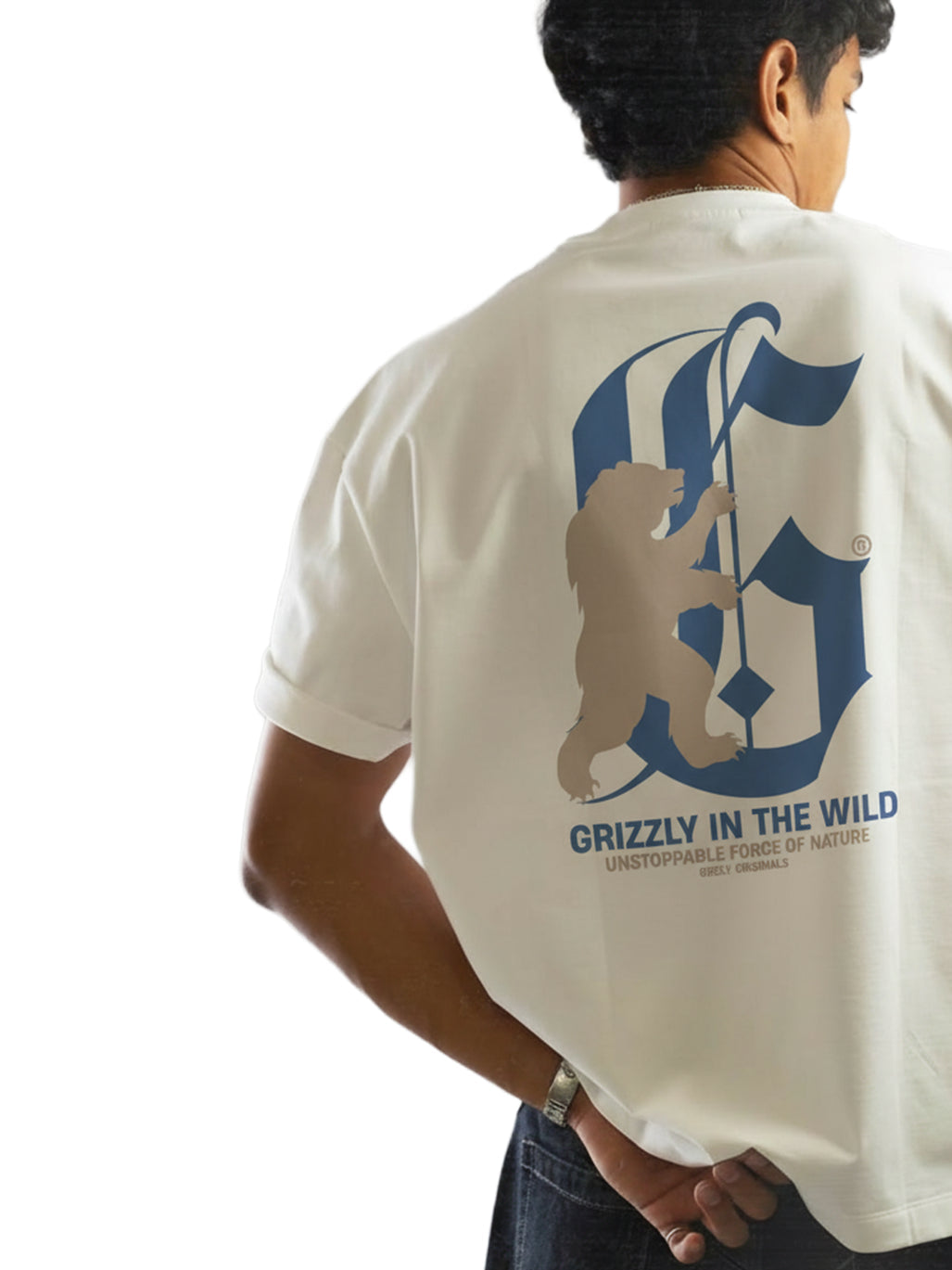 Person wearing a white t-shirt with a grizzly bear graphic and text on the back.
